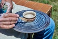 On the potter`s wheel revolve a spinning of a clay cup Royalty Free Stock Photo