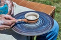 On the potter`s wheel revolve a spinning of a clay cup Royalty Free Stock Photo