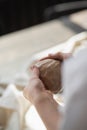 The potter`s woman hands are shaping a cup from a clay. The process of creating pottery. The master ceramist works in Royalty Free Stock Photo