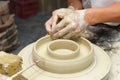 Potter shaping clay in pottery