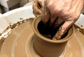 Women's hands making a kitchen object from clay on a potter's wheel manual potter wheel is rotated on a vertical Royalty Free Stock Photo