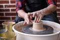 Potter wheel and hands of craftsman making a jug Royalty Free Stock Photo