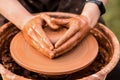 Potter work with clay. Hands of man in shape of heart in clay on pottery wheel mold vase. Royalty Free Stock Photo