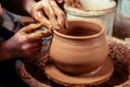 Potter at work. Workshop. Hands of a potter, creating an earthen jar on the circle Royalty Free Stock Photo