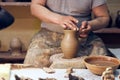 Potter at work. Workshop place. The hands of a potter creating jar on the circle Royalty Free Stock Photo