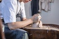 Potter working on a Potter`s wheel making a vase. Young woman forming the clay with hands creating jug in a workshop Royalty Free Stock Photo