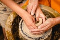 Potter working on potters wheel with clay. Process of making ceramic tableware in pottery workshop Royalty Free Stock Photo