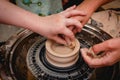 Potter working on potters wheel with clay. Process of making ceramic tableware in pottery workshop Royalty Free Stock Photo