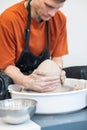 A potter working on a potter& x27;s wheel. Vertical photo. Royalty Free Stock Photo