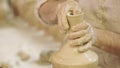 Potter works. Crockery creation process in pottery on potters wheel