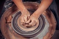 Hands of the master potter and vase of clay on the potter& x27;s wheel close-up. Master crock. Twisted potter& x27;s wheel