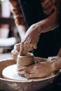 The potter works in the workshop. Potter makes a jug on a potter`s wheel