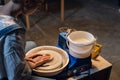 on a potter's wheel, a young potter makes a preparation for a pot out of clay.