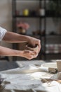 The potter& x27;s woman hands are shaping a cup from a clay. The process of creating pottery. The master ceramist works in Royalty Free Stock Photo