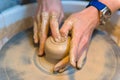 Pottering - creating a clay cup in process Royalty Free Stock Photo