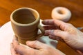 Pottering - creating a clay cup in process Royalty Free Stock Photo
