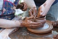 Potters hands creating a clay pot