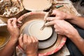A potters hands guiding pupil hands to help him Royalty Free Stock Photo