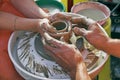 Potters' hands guiding woman's hands Royalty Free Stock Photo