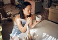 Pottery, art and ceramics with an asian woman in a studio for design or a creative hobby as an artisan. Manufacturing