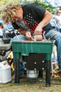 Pottery Artist Forms Clay Bowl With Hands At Arts Festival