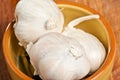 Pottery bowl of three garlic heads