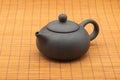 Pottery Chinese teapot on bamboo mat Royalty Free Stock Photo
