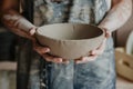 Pottery, clay, ceramics art concept - closeup on hands of young master with the large plate from fireclay Royalty Free Stock Photo