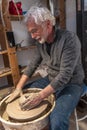 Pottery craftsman working on a potters wheel to make a bowl