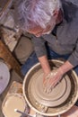 Pottery craftsman working on a potters wheel to make a bowl
