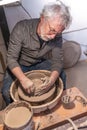 Pottery craftsman working on a potters wheel to make a bowl