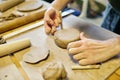 Pottery. A girl with a string in her hands and clod clay