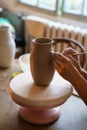 Pottery hobby: hands of professional ceramist work on potter vase in studio create jug of raw clay Royalty Free Stock Photo