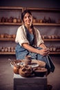 Pottery master demonstrates a finished clay bowl in the workshop . Making pottery.