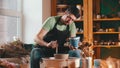 Pottery - the master is sitting in his workshop among his tools with blue paint Royalty Free Stock Photo