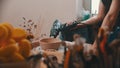 Pottery - the master is sitting in his workshop among his tools and drying a clay bowl Royalty Free Stock Photo