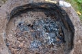 Hidden pottery pieces inside earthen chamber of primitive pit fire kiln