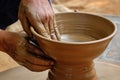 Pottery - skilled wet hands of potter shaping the clay on potter wheel Royalty Free Stock Photo