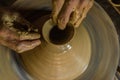 Pottery wheel with potter`s hands . Royalty Free Stock Photo