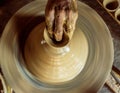 Pottery wheel with potter`s hands . Royalty Free Stock Photo