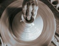 Pottery wheel with potter`s hands . Royalty Free Stock Photo