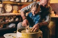 Pottery workshop. Grandpa teaches granddaughter pottery. Clay modeling