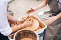 Pottery workshop. Hands of adult and child making pottery, working with wet clay closeup. Process of making bowl from clay on Royalty Free Stock Photo