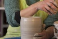 Potter`s hands making a clay pot on pottery