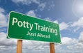 Potty Training Just Ahead Green Road Sign Over Clouds and Blue Sky