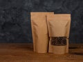 Pouch bag mockup. Blank brown kraft paper pack with coffee beans wooden background advertising copy space