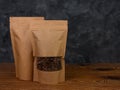 Pouch bag mockup. Blank brown kraft paper pack with coffee beans wooden background advertising copy space