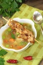 Poultry consomme soup with green and bread Royalty Free Stock Photo