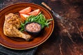 Poultry dish - roasted chicken legs with vegatables salad. Dark background. Top view. Copy space