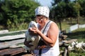 Poultry farm - a woman feeding geese